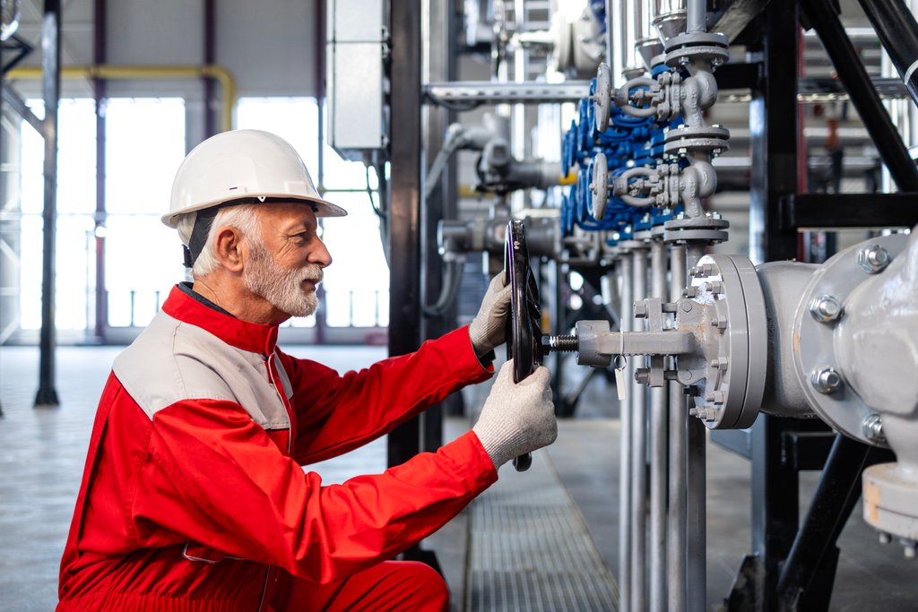 Production worker in a high-visibility jacket at the tank farm